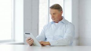 stock-footage-business-office-oldness-school-and-education-concept-old-man-with-tablet-computer-at-home